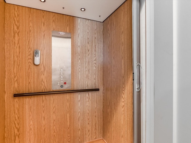 room details featuring wooden walls and elevator