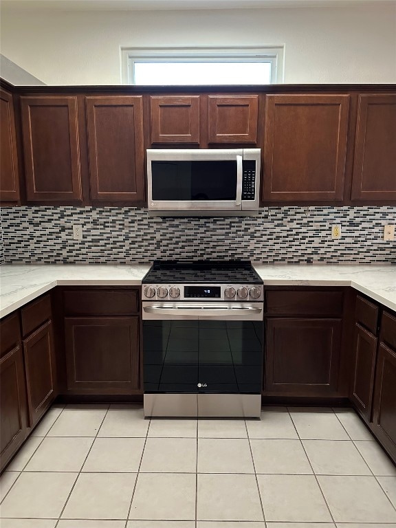 kitchen featuring decorative backsplash, stainless steel appliances, and a wealth of natural light