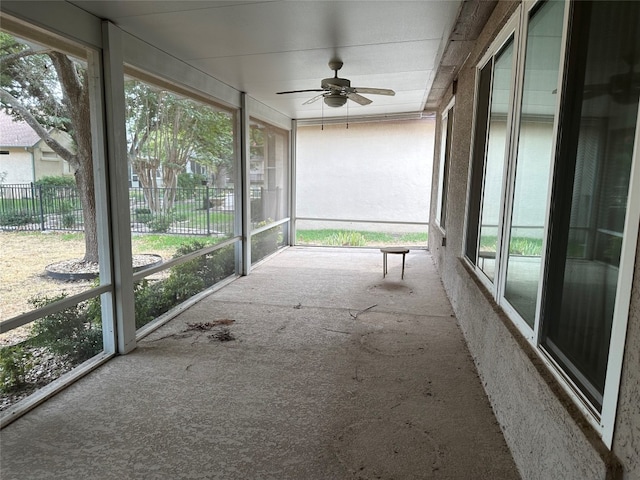 unfurnished sunroom with ceiling fan and a healthy amount of sunlight