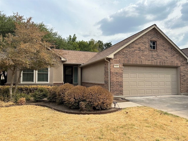 single story home with a garage and a front lawn