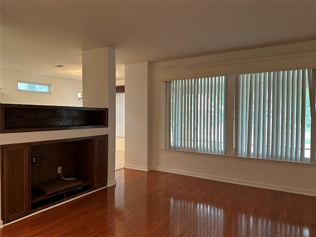 unfurnished living room featuring dark hardwood / wood-style floors