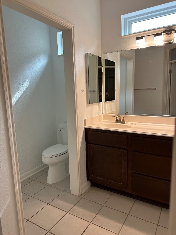 bathroom with tile patterned flooring, vanity, and toilet