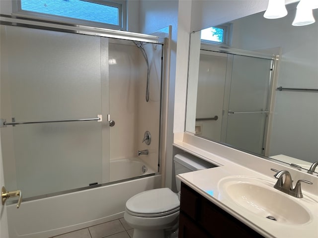 full bathroom with toilet, vanity, tile patterned floors, and bath / shower combo with glass door