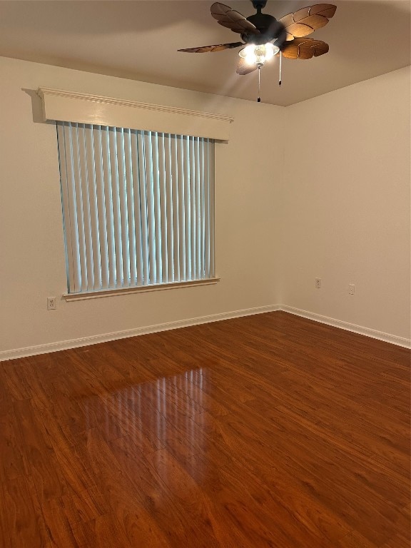 unfurnished room featuring ceiling fan and dark hardwood / wood-style flooring