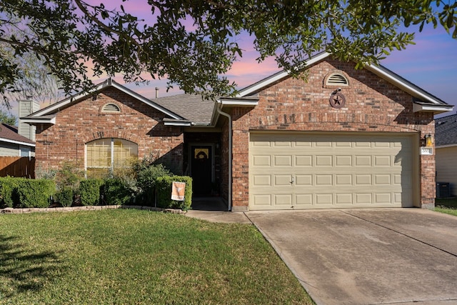 view of front of home with central air condition unit, a garage, and a lawn