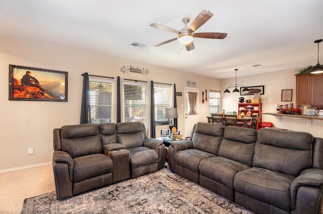 living room featuring carpet flooring and ceiling fan