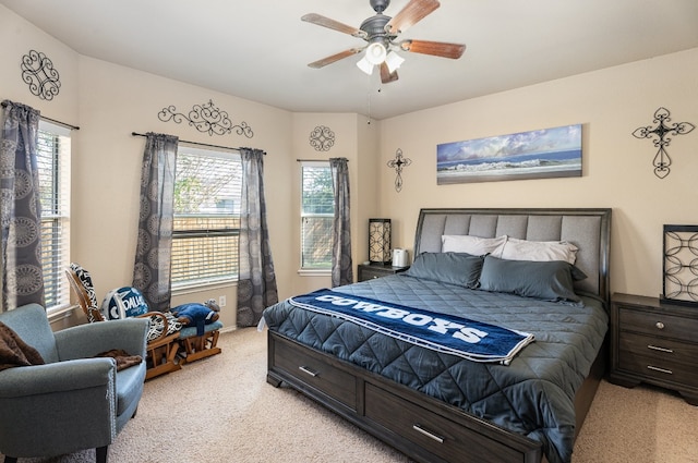 carpeted bedroom featuring ceiling fan and multiple windows