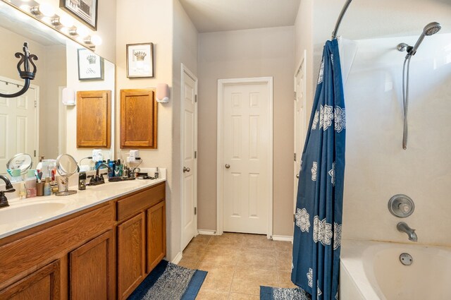 bathroom with tile patterned flooring, vanity, and shower / bath combo