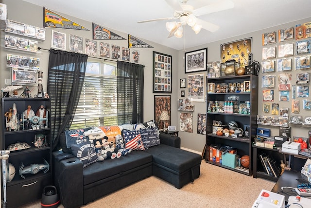 living area featuring carpet flooring and ceiling fan