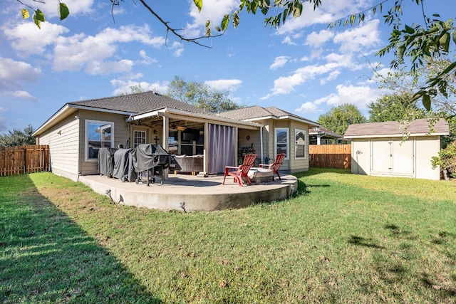 rear view of house with a shed, a patio area, and a lawn