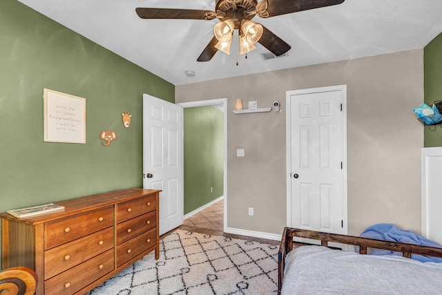 tiled bedroom with ceiling fan