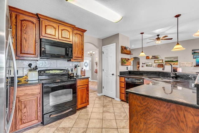 kitchen with black appliances, light tile patterned floors, ceiling fan, sink, and decorative light fixtures