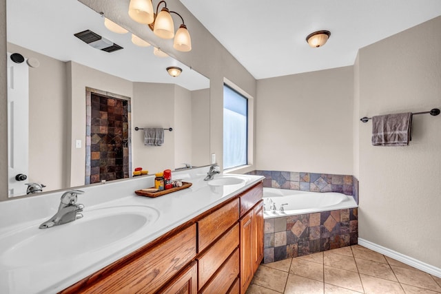 bathroom with vanity, tile patterned floors, and tiled bath