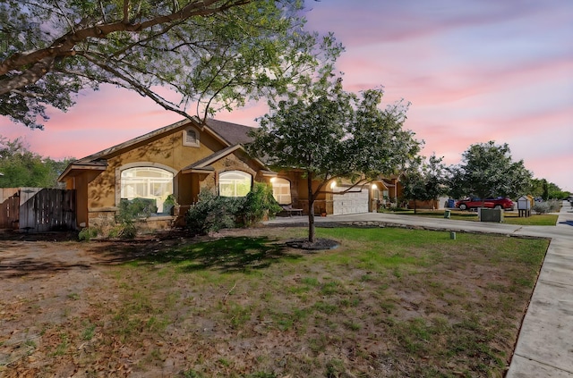 view of front of property with a yard and a garage