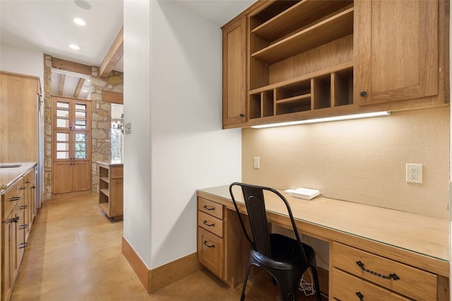 office featuring beamed ceiling and built in desk