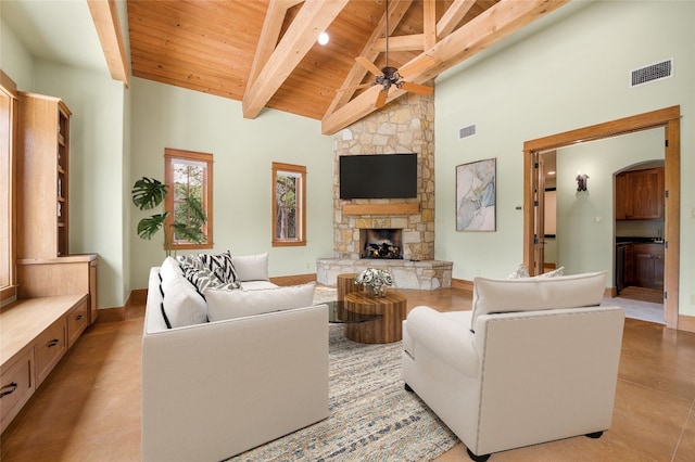 tiled living room featuring wooden ceiling, high vaulted ceiling, ceiling fan, a fireplace, and beamed ceiling