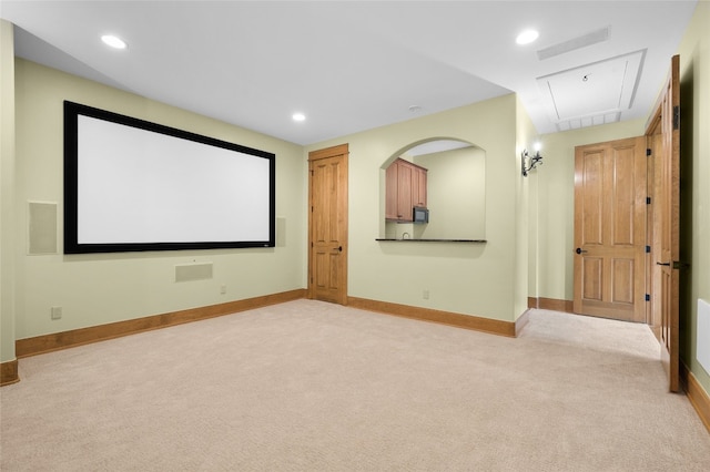 cinema room featuring light carpet