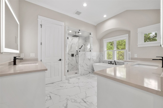 bathroom with vanity, a shower with shower door, and vaulted ceiling