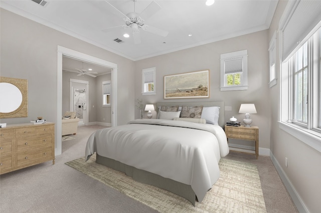 carpeted bedroom featuring ceiling fan, crown molding, and connected bathroom