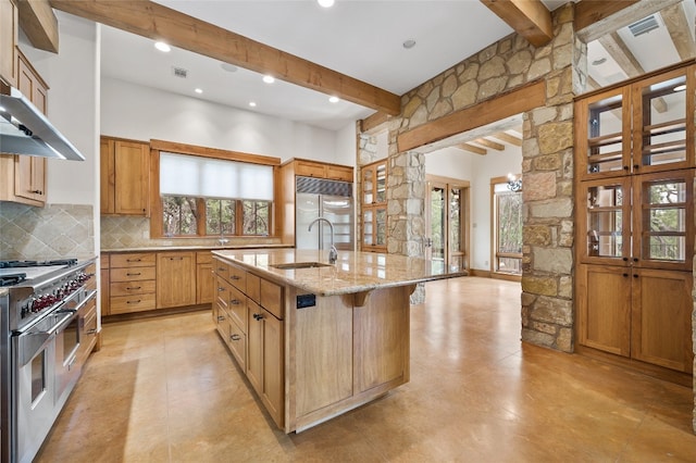 kitchen with beam ceiling, a wealth of natural light, and premium appliances