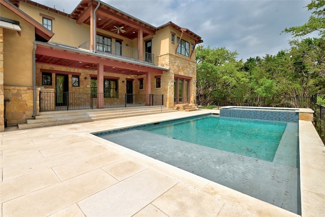 view of swimming pool featuring a patio and ceiling fan