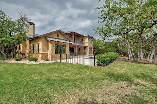 back of house featuring a patio and a lawn