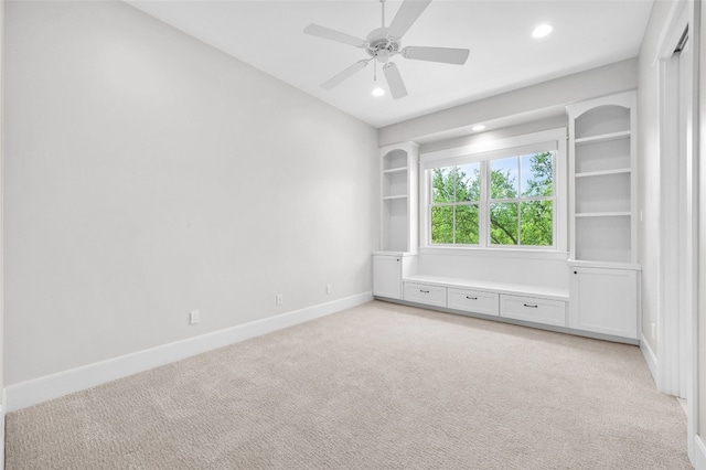 spare room with light carpet and ceiling fan