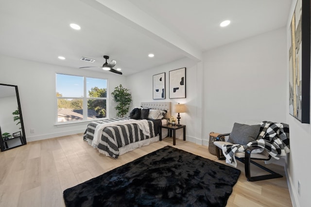 bedroom featuring beam ceiling, light hardwood / wood-style floors, and ceiling fan