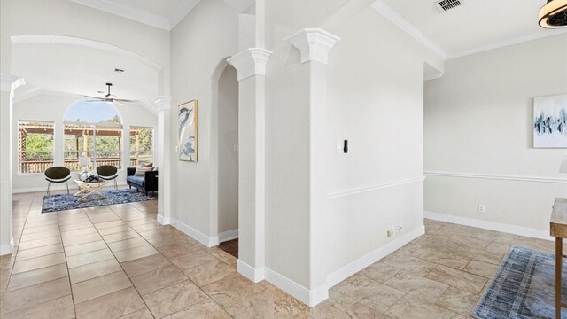 hallway featuring ornate columns, vaulted ceiling, and ornamental molding