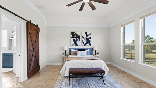 bedroom with a barn door, ensuite bath, ceiling fan, and crown molding