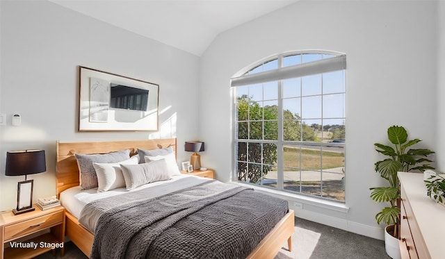 carpeted bedroom with vaulted ceiling