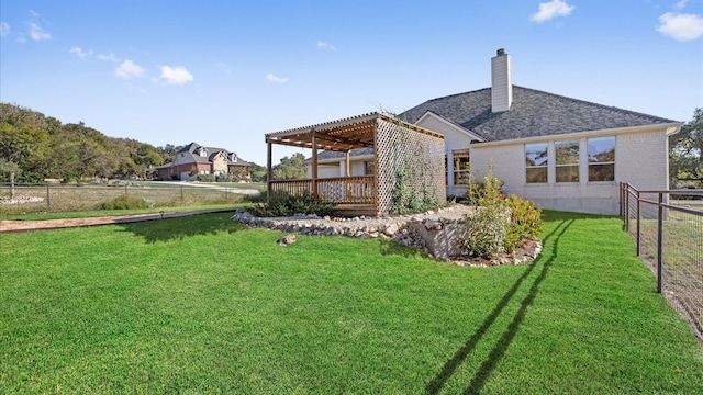 rear view of property featuring a pergola, a yard, and a wooden deck