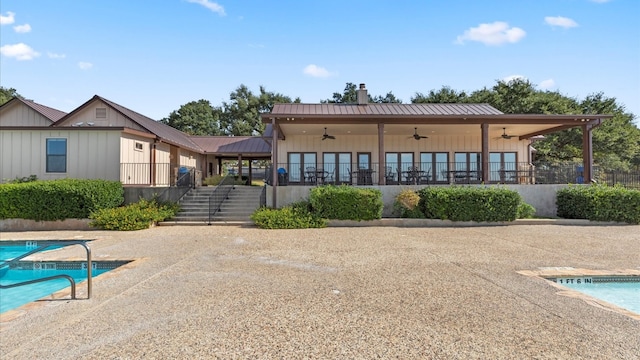 back of house with ceiling fan, a community pool, and a patio