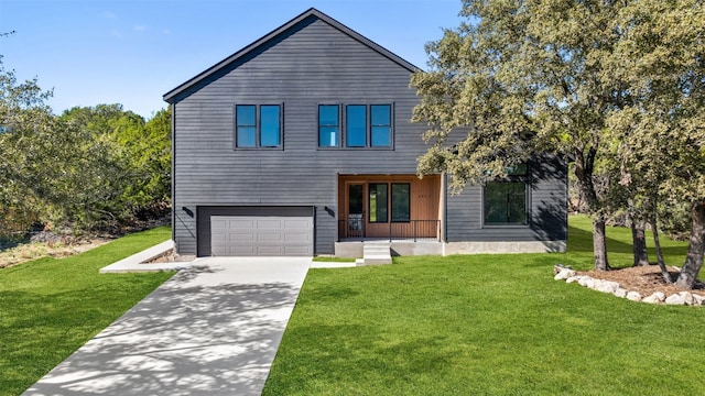 modern home featuring a front lawn, covered porch, and a garage