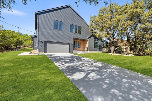 view of front of home with a front yard and a garage