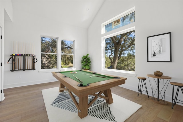 rec room featuring hardwood / wood-style flooring, high vaulted ceiling, and pool table