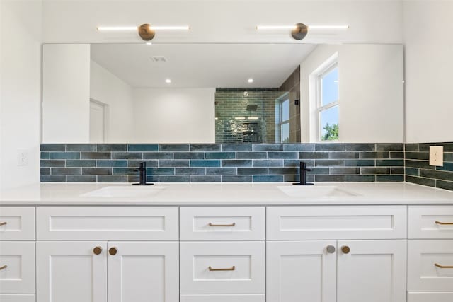 bathroom with vanity, a shower with door, and backsplash