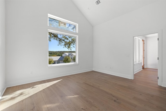 bonus room with high vaulted ceiling and wood-type flooring