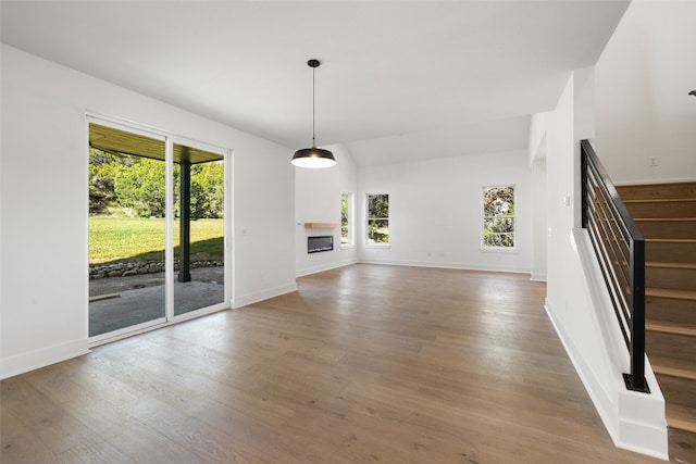 unfurnished living room with plenty of natural light and hardwood / wood-style flooring