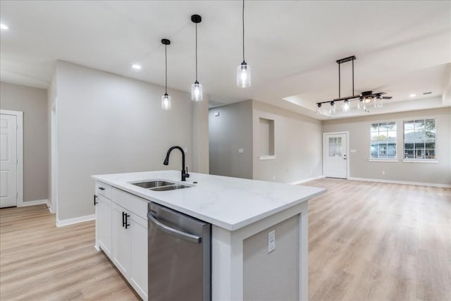 kitchen featuring an island with sink, sink, white cabinets, hanging light fixtures, and stainless steel dishwasher