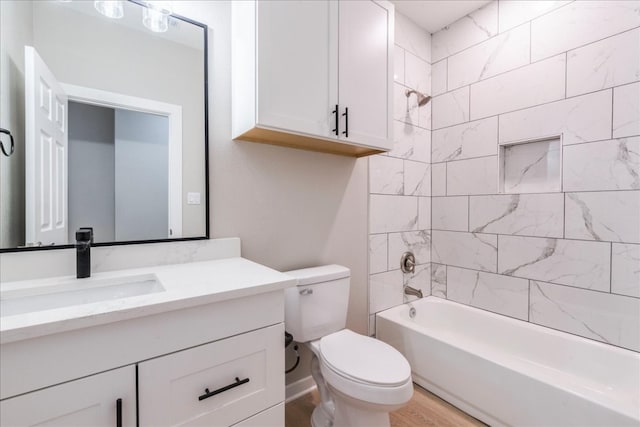 full bathroom with hardwood / wood-style flooring, tiled shower / bath combo, toilet, and vanity