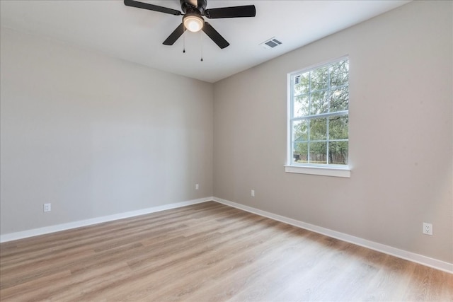 spare room with ceiling fan and light wood-type flooring