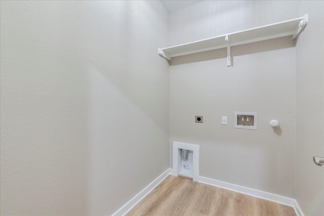 washroom with washer hookup, light hardwood / wood-style floors, hookup for a gas dryer, and hookup for an electric dryer