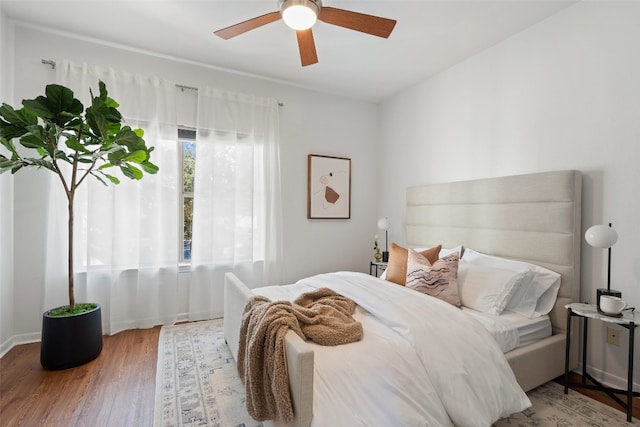 bedroom with hardwood / wood-style floors and ceiling fan