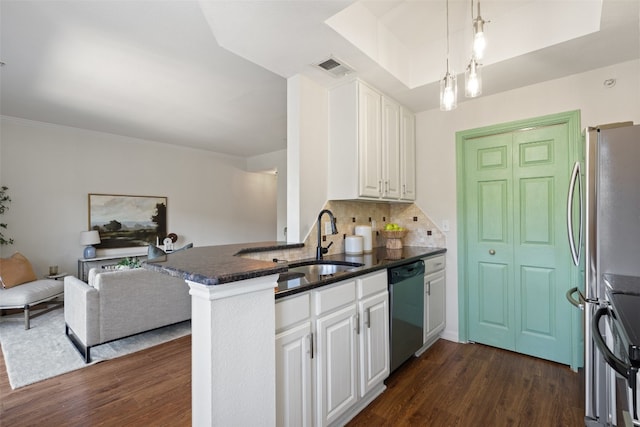 kitchen with sink, white cabinetry, appliances with stainless steel finishes, kitchen peninsula, and pendant lighting