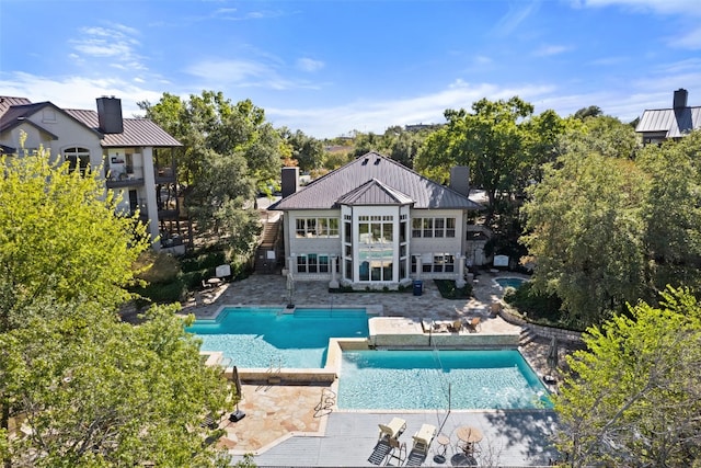 back of house featuring pool water feature and a patio area