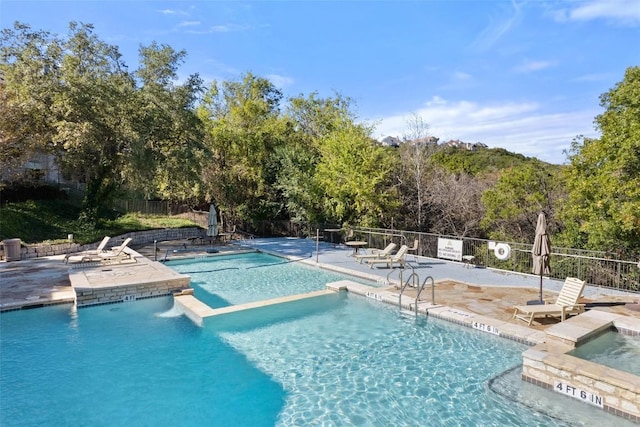 view of pool featuring a patio and a community hot tub