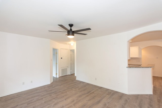 spare room with light wood-type flooring and ceiling fan