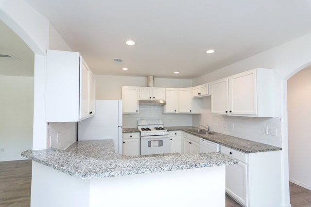 kitchen featuring kitchen peninsula, white cabinets, and white appliances