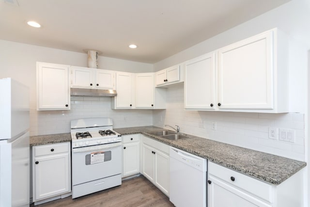 kitchen featuring white cabinetry, sink, white appliances, and hardwood / wood-style flooring